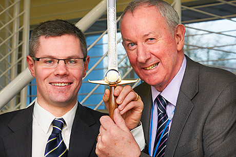 Sharp practice: Planning minister Derek Mackay (left) presents the sword to Gerry Ralph, the college’s senior instructor.