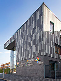 FIBRE cement panels in three colours of grey allowed the architect for an education complex to emulate the appearance of stone or slate bands.