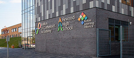 FIBRE cement panels in three colours of grey allowed the architect for an education complex to emulate the appearance of stone or slate bands.