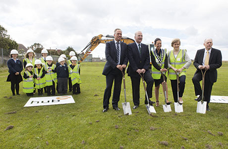 Deputy First Minister Nicola Sturgeon took part in the turf cutting under the watchful eye of pupils.
