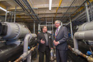 Galashiels, Borders College Campus, Netherdale, UK. 08.12.2015. First in UK, Heat from Sewage scheme Energy Minister Fergus Ewing, today launched the first SHARC energy recovery system at Borders College Campus, in Galashiels. Part of a 20 year purchase agreement, providing 95% of the campus heating needs. Pictured here with Russ Burton, CEO of SHARC Energy Systems in the new plant. (Photo: Rob Gray)