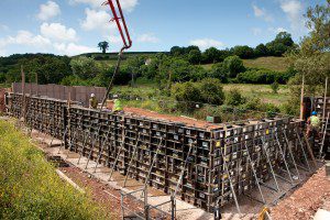 Photography by Roy Riley 0781 6547063 03.07.09 Images of Concrete being poured into formwork from Mabey Hire who supply modular concrete formwork for the construction of a reinforced concrete retaining wall as part of a social housing development in Newton Abbott, Devon