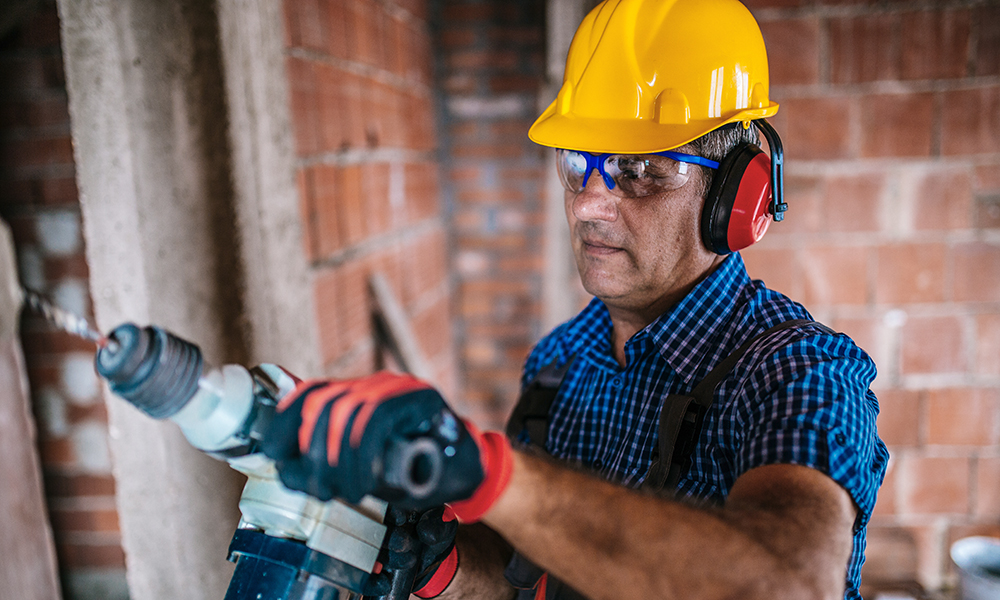 Working drilling, wearing hearing protection