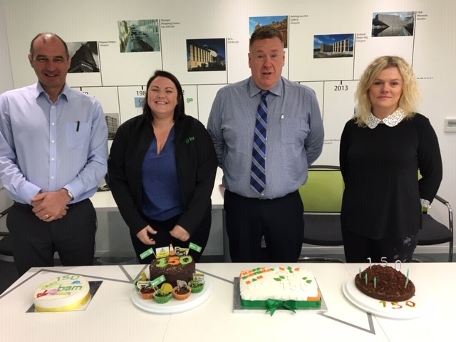 BAM staff celebrating anniversary with cake