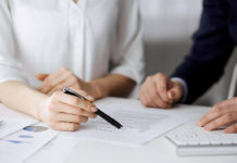 Unknown,Businessman,And,Woman,Discussing,Contract,In,Office.,Closeup.business,People