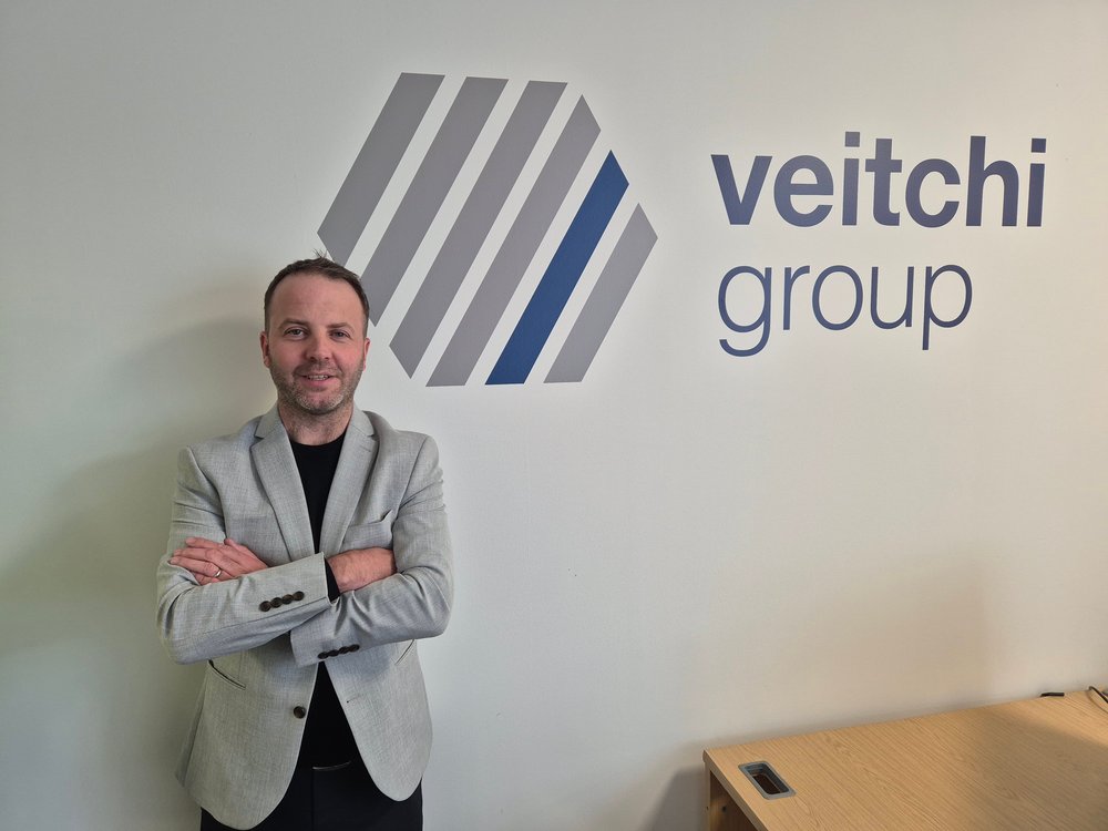 MD standing in front of Veitchi Group sign