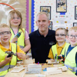 Graeme with pupils at Stoneyburn Primary School. Image credit: Robert Perry