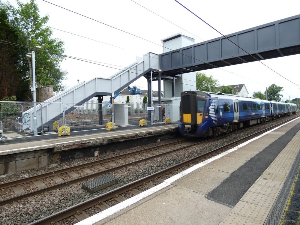 Train passing under new footbridge at Uddingston Railway Station