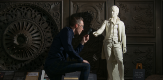 Collections Registrar Ross Irving with statue