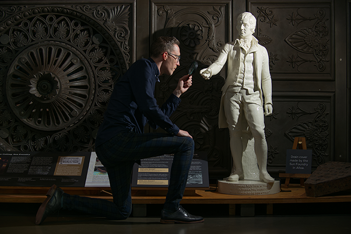 Collections Registrar Ross Irving with statue