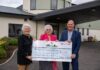 Sandy Macleod presenting a £10,000 cheque to Elsie Normington and Elizabeth Mackintosh