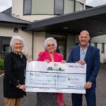 Sandy Macleod presenting a £10,000 cheque to Elsie Normington and Elizabeth Mackintosh