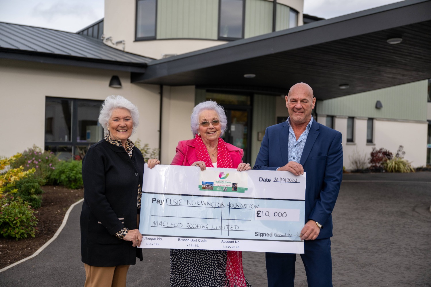 Sandy Macleod presenting a £10,000 cheque to Elsie Normington and Elizabeth Mackintosh