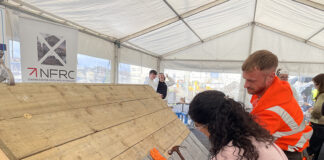 NFRC image. A student lays slate on a training rig during a skills demonstration at The Engine Shed, Stirling