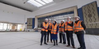 Group in orange high-vis vests visit site of Rothesay Pavilion revamp