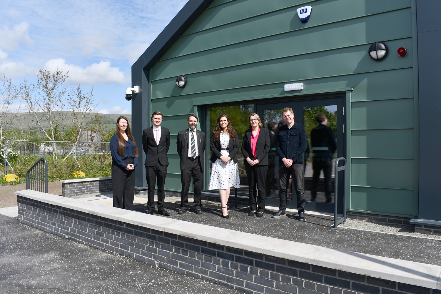 Project team standing outside new centre