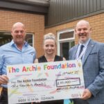 Macleod Roofing backs The Archie Foundation Group picture holding cheque