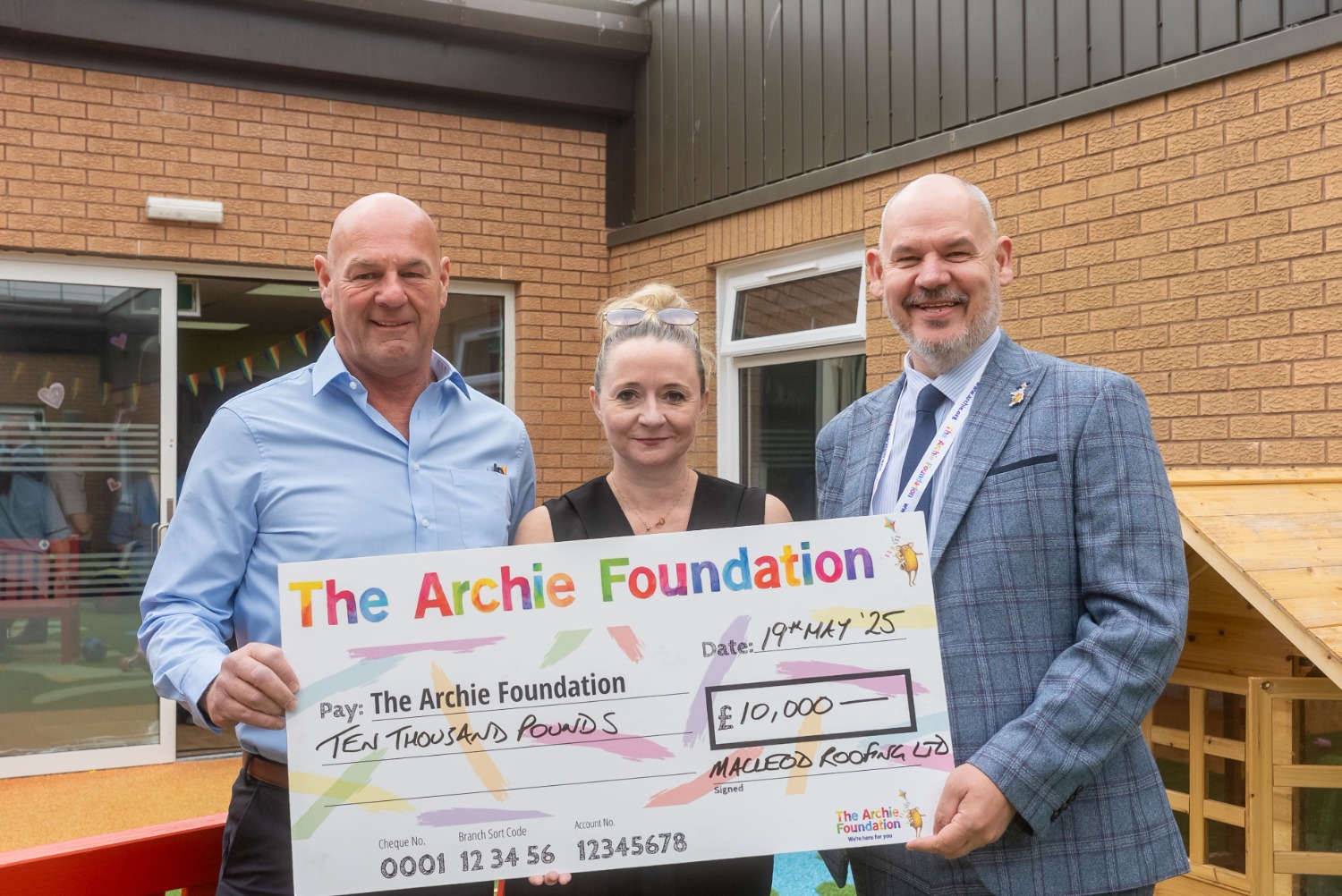 Group picture holding cheque