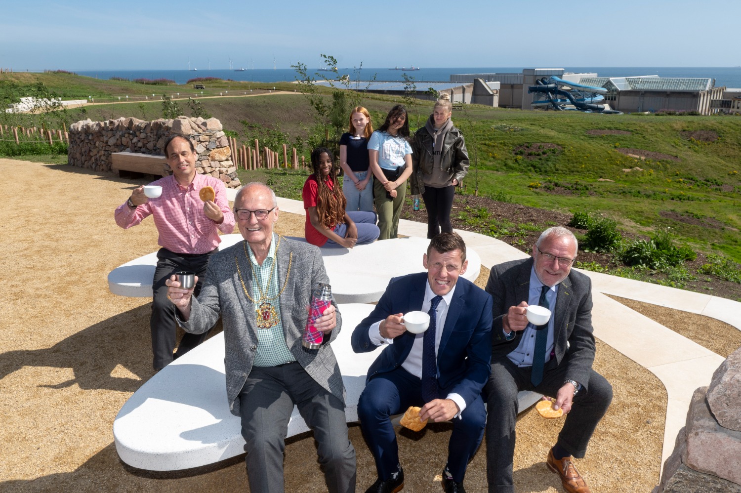 L to R – Cllr Martin Greig, the Lord Provost Dr David Cameron, Richard Park, chief executive of hub North Scotland, and Elliot Robertson, Chief Executive Officer, Robertson Construction Group, with some of the Young Ambassadors in the background, on one of the viewing platforms at the new-look Broadhill