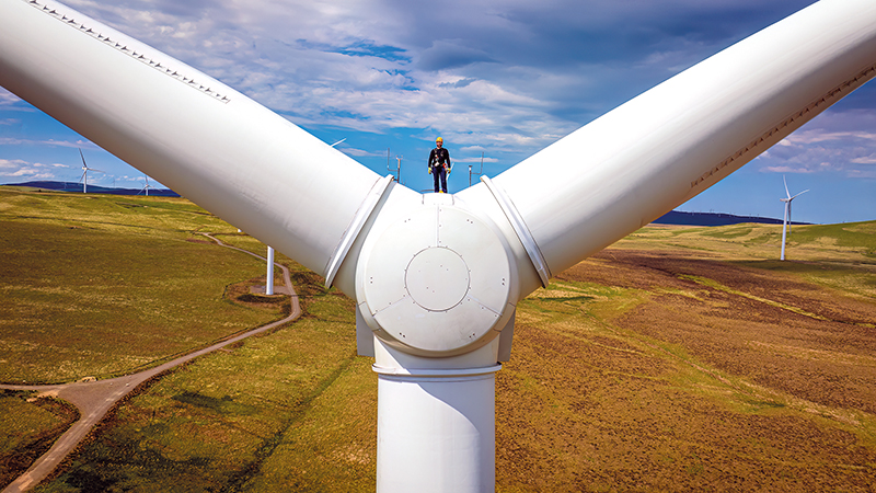 Worker on top of wind turbine