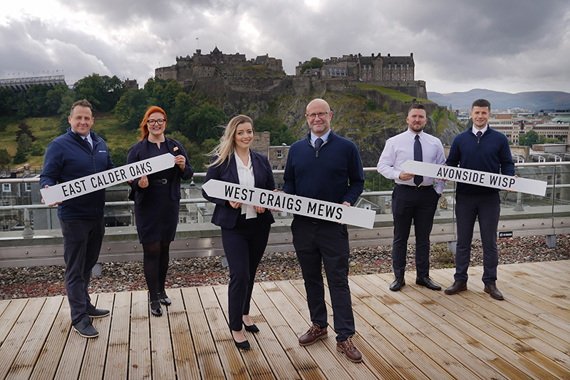 Miller Homes team holding signs of upcoming developments