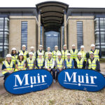 Construction workers in front of Edinburgh office building
