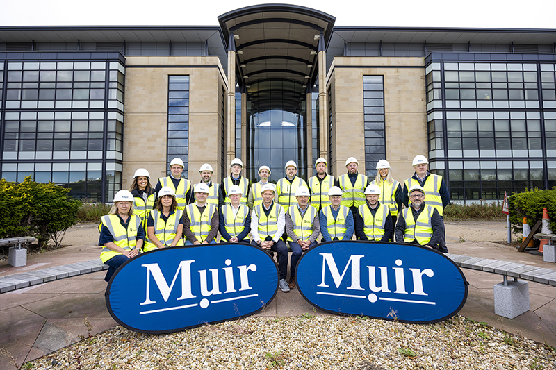 Construction workers in front of Edinburgh office building