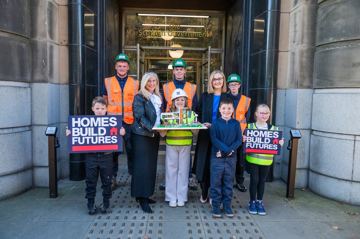 ATTACHMENT DETAILSHomes-Build-Futures-campaign-launch-L-R-Jane-Wood-CEO-Homes-for-Scotland-and-Cabinet-Secretary-for-Housing-Mairi-McAllan-MSP-with-future-voters-and-housing-apprentices
