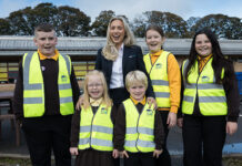 Housebuilder donates hi-vis vests to help keep children safe Children in hi-vis vests to promote safety campaign