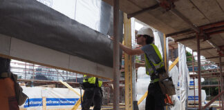 Prefabricated wooden trusses being installed on site