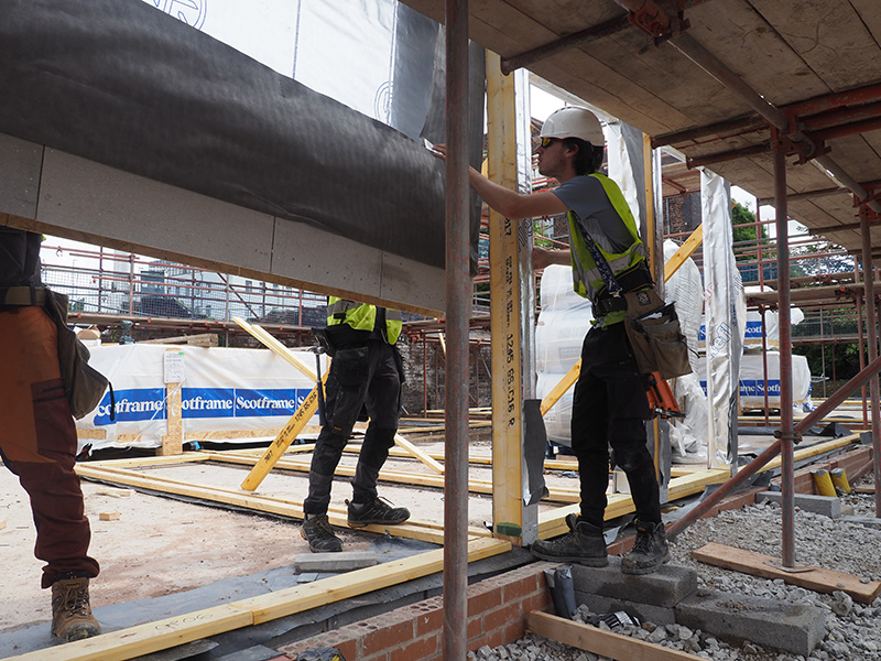 Prefabricated wooden trusses being installed on site