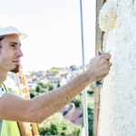 Bell acquires Paisley-based painting and decorating specialist Worker painting outside of a house