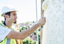 Bell acquires Paisley-based painting and decorating specialist Worker painting outside of a house