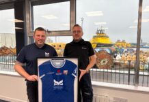 MPA Harbour Master, Ross Marshall, gifting Brage Viking Captain, Jan Pedersen, a Montrose FC t-shirt with proceeds going to PoppyScotland to mark the 1GWh milestone
