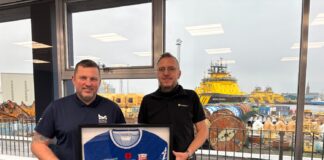 MPA Harbour Master, Ross Marshall, gifting Brage Viking Captain, Jan Pedersen, a Montrose FC t-shirt with proceeds going to PoppyScotland to mark the 1GWh milestone