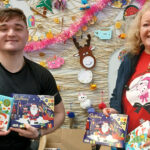 Loretta Higgins from the Paisley branch handing over gifts to a STAR Project representative