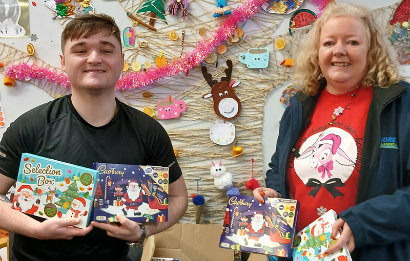 Loretta Higgins from the Paisley branch handing over gifts to a STAR Project representative