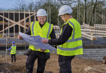 Construction firms urged to step up mentoring efforts to address skills gaps Construction workers in conversation