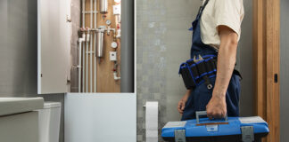 Plumber working in bathroom