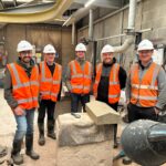 Visitors on tour of a stonemason carving centre