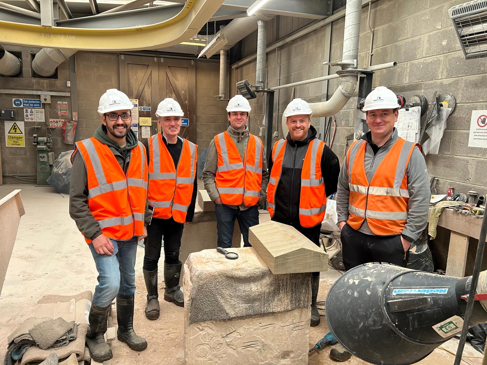 Visitors on tour of a stonemason carving centre