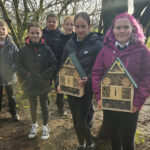 School pupils with bug hotels