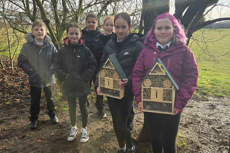 School pupils with bug hotels