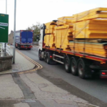 Lorries passing road sign