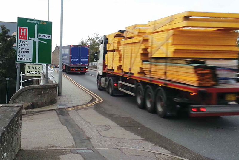 Lorries passing road sign