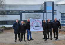 Construction workers holding banner depicting West Highland Way charity trek