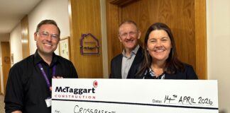 Large cheque being handed over by McTaggart Construction to Crossbasket House