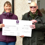 Gillian Smith (QCCC) and Ian Crawford (Manor Estates) with big cheque handover