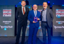 Bracewell earns award recognition for collaborative approach Bracewell on stage receiving award