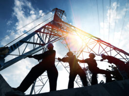 silhouette workers on background of construction
